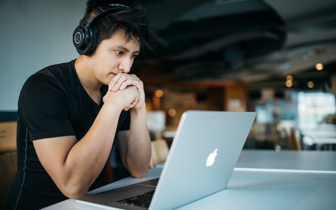Student at laptop computer with headphones on